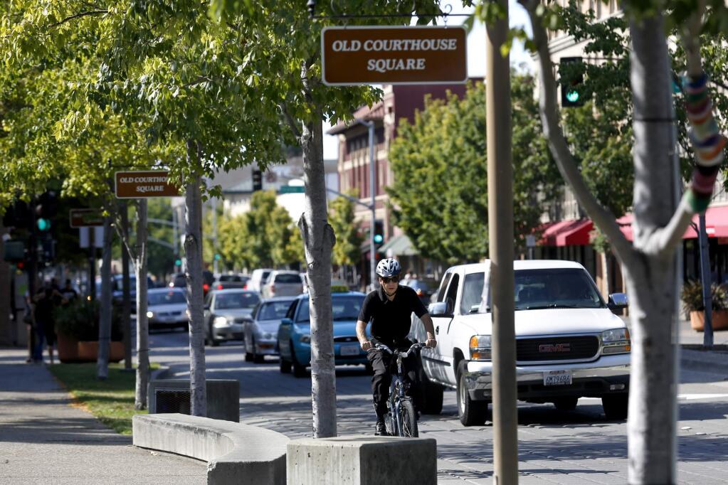7/27/2014:T8: A cyclist rides on Mendocino Avenue through Old Courthouse Square in Santa Rosa on July 13. 7/14/2014:B2: Motorists and a cyclist drive along Mendocino Avenue through Old Courthouse Square in Santa Rosa on Sunday. PC: Motorists and a cyclist drive along Mendocino Ave through Old Courthouse Square in Santa Rosa, on Sunday, July 13, 2014. (BETH SCHLANKER/ The Press Democrat)