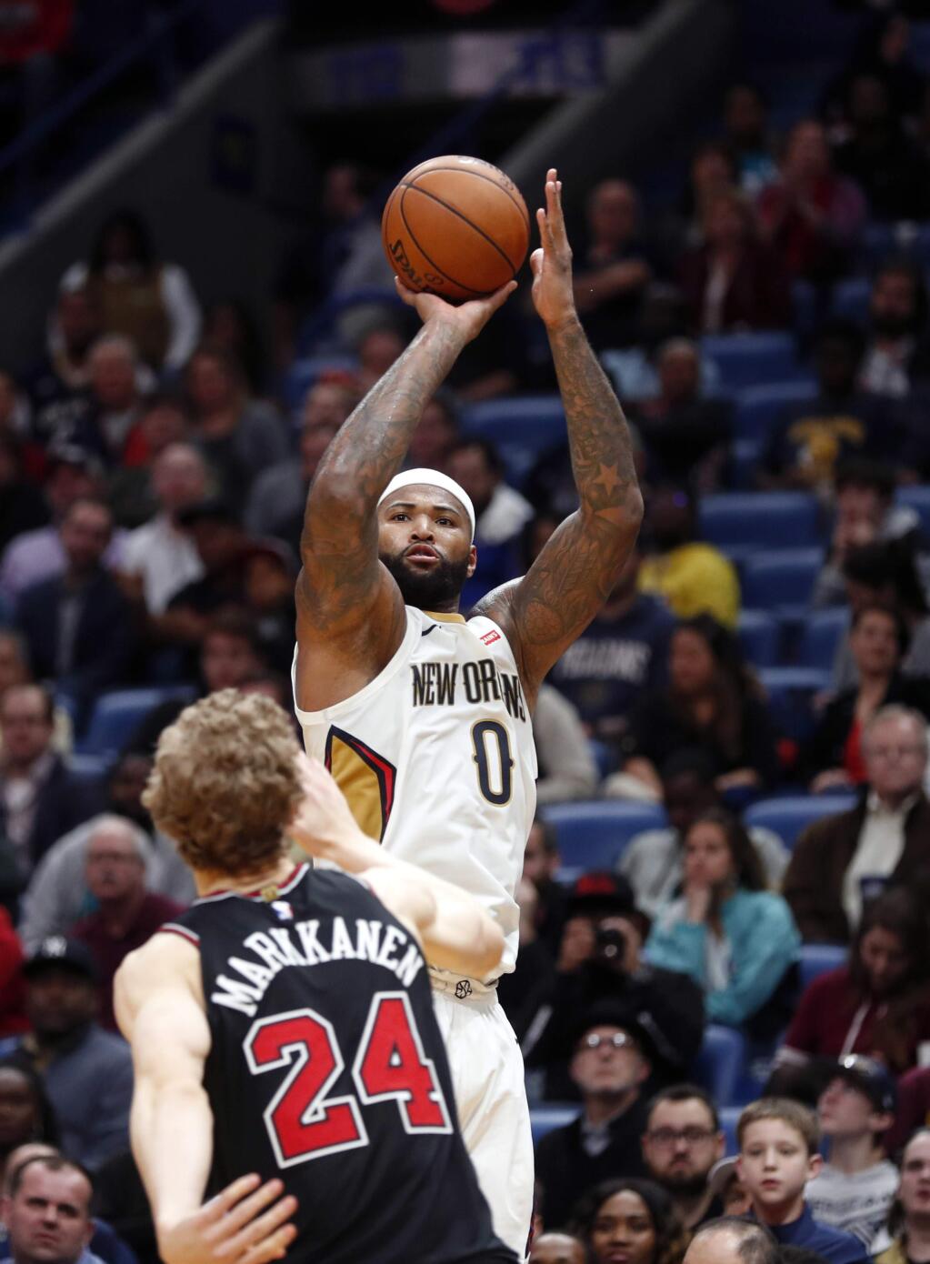 New Orleans Pelicans center DeMarcus Cousins shoots over Chicago Bulls forward Lauri Markkanen in the second half in New Orleans, Monday, Jan. 22, 2018. The Pelicans won in double overtime, 132-128. (AP Photo/Gerald Herbert)