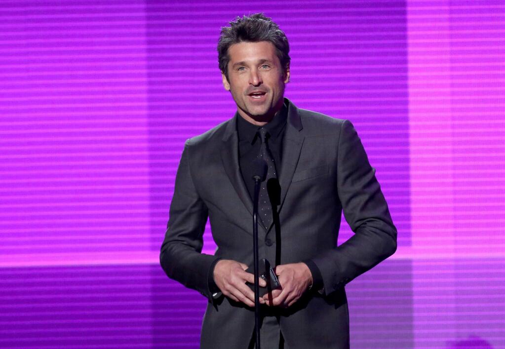 FILE- In this Nov. 23, 2014 file photo, Patrick Dempsey presents the award for pop/rock band, duo or group on stage at the 42nd annual American Music Awards in Los Angeles. In the Thursday, April 23, 2015, episode of 'Grey's Anatomy' Dempsey made a surprise departure from the series, when his character Derek 'McDreamy' Shepherd died from injuries suffered when he was blindsided by a truck. (Photo by Matt Sayles/Invision/AP, File)