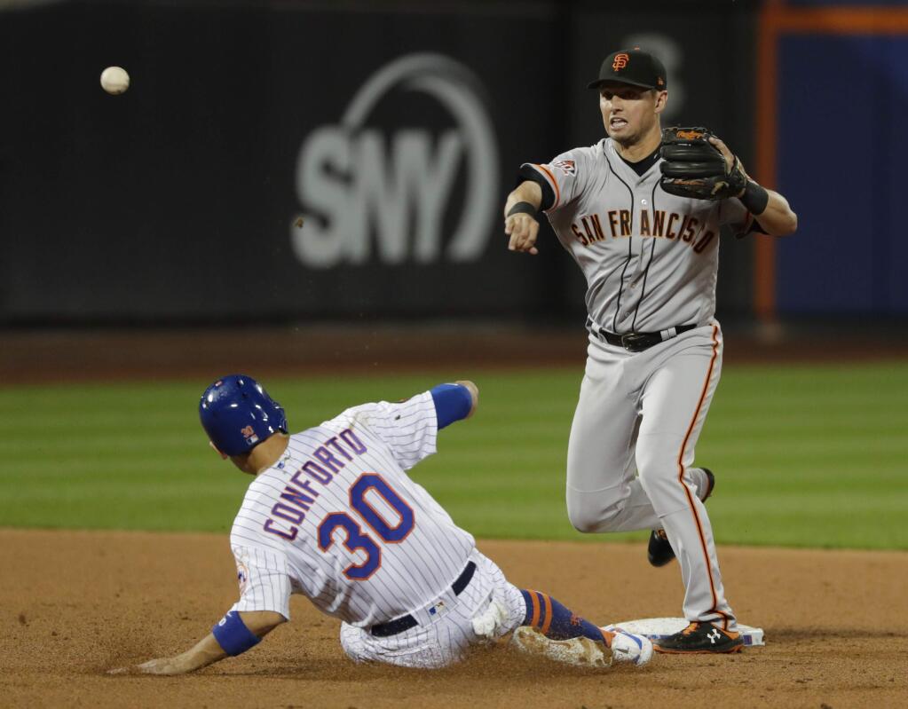 San Francisco Giants' Joe Panik, right, throws out New York Mets' Amed Rosario at first base after forcing out Michael Conforto during the seventh inning of a baseball game Monday, Aug. 20, 2018, in New York. (AP Photo/Frank Franklin II)