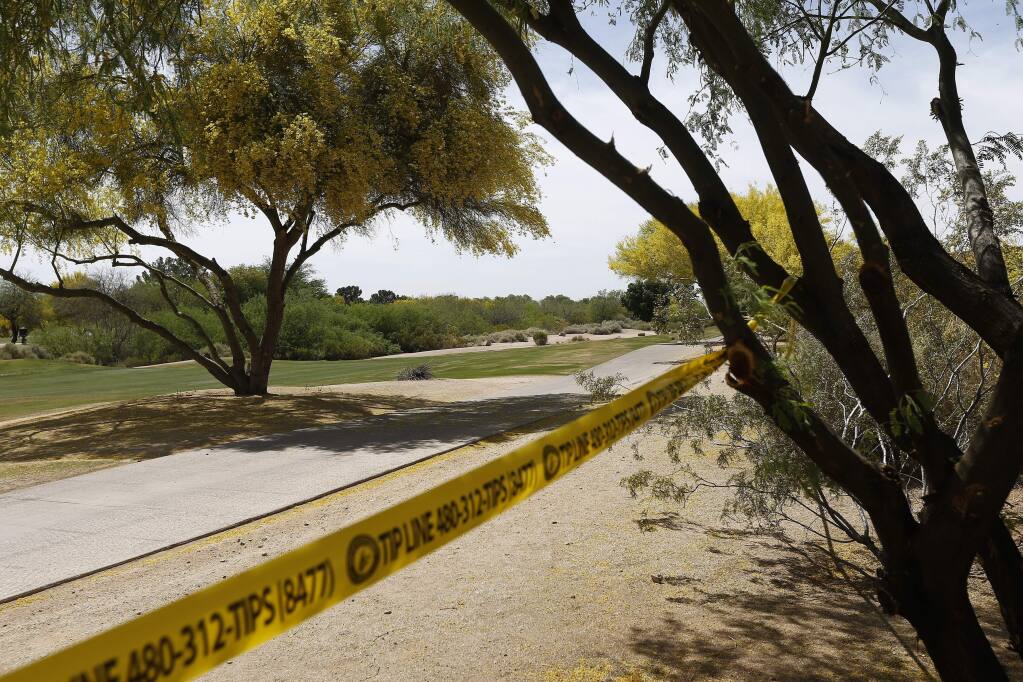 Police tape cordon off an area near the site of a plane crash that killed several people Tuesday, April 10, 2018, in Scottsdale, Ariz. A National Transportation Safety Board investigator is at the scene of the deadly crash and authorities are working to identify the people killed in a Piper PA-24 Comanche that went down Monday night shortly after takeoff from the Scottsdale Airport. (AP Photo/Ross D. Franklin)