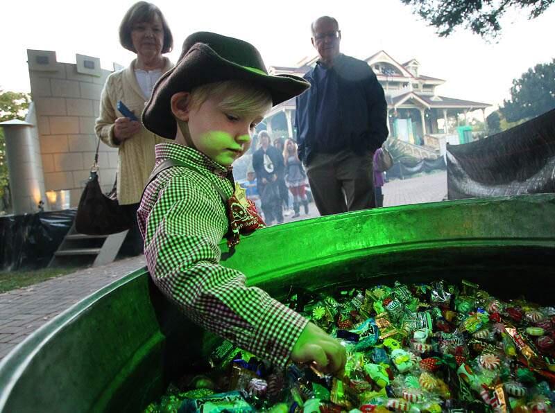 Jameson Manville, 3, reaches for candy being given out at the McDonald Mansion in Santa Rosa on Thursday, October 31, 2013. (Conner Jay/The Press Democrat)