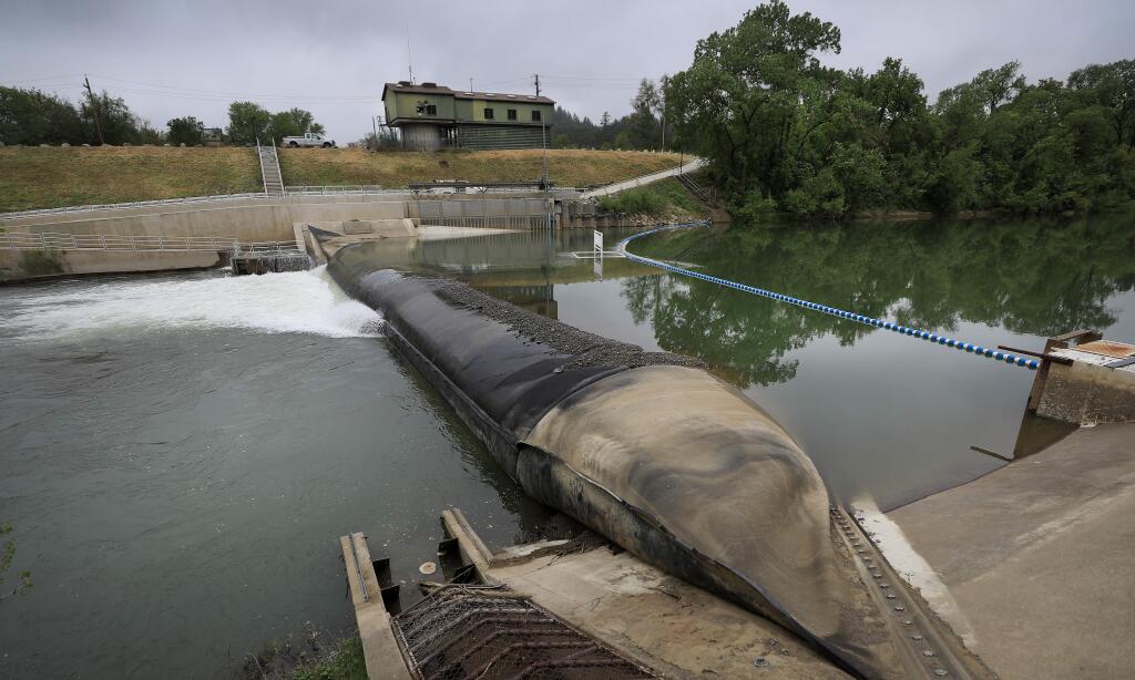 Photos by Kent Porter / The Press DemocratThe rubber dam on the Russian River, downstream from the Wohler Bridge, is about halfway inflated Thursday as water begins to back up near Forestville. By Friday, the dam was 99% full, said Barry Dugan, a spokesman for the county water agency.