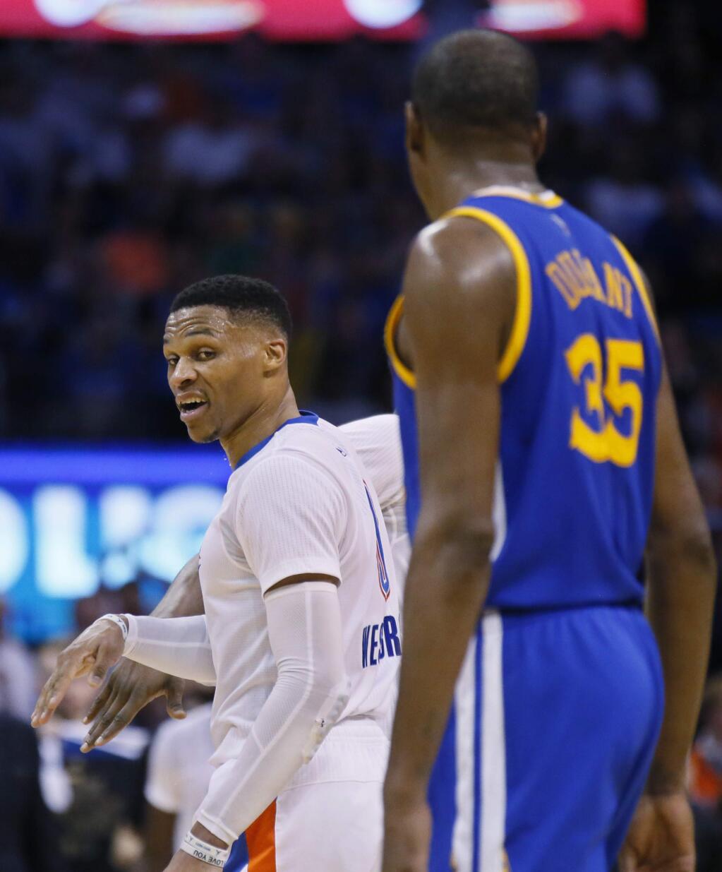 In this Feb. 11, 2017, file photo, Oklahoma City Thunder guard Russell Westbrook, left, comments to Golden State Warriors forward Kevin Durant as they walk offcourt for a timeout in the third quarter in Oklahoma City. (AP Photo/Sue Ogrocki, File)