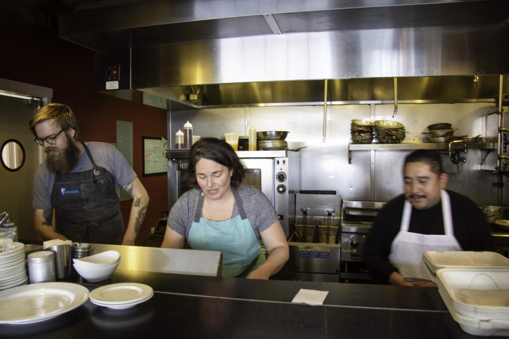 Chef Liza Hinman of Spinster Sisters preparing to-go meals. Heather Irwin/PD