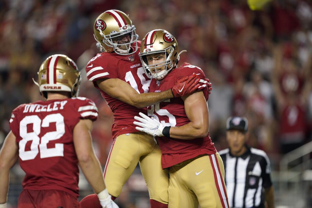 San Francisco 49ers tight end George Kittle, right, celebrates with Dante Pettis, center, and Ross Dwelley after scoring against the Cleveland Browns during the second half in Santa Clara, Monday, Oct. 7, 2019. (AP Photo/Tony Avelar)