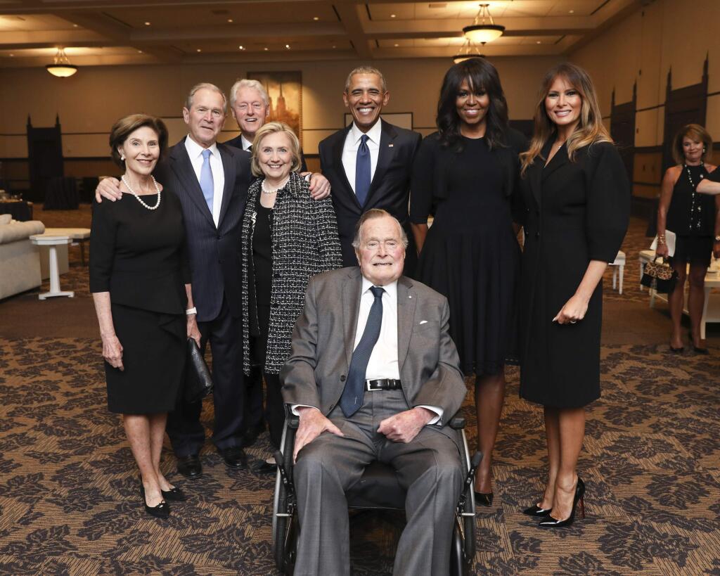This Saturday, April 21, 2018, photo provided by the Office of former U.S. President George H.W. Bush, shows Bush, front center, and past presidents and first ladies Laura Bush, from left, George W. Bush, Bill Clinton, Hillary Clinton, Barack Obama, Michelle Obama and Melania Trump in a group photo at the funeral service for first lady Barbara Bush, in Houston. Barbara Bush died Tuesday, April 17. She was 92. (Paul Morse/Courtesy of Office of George H.W. Bush via AP)