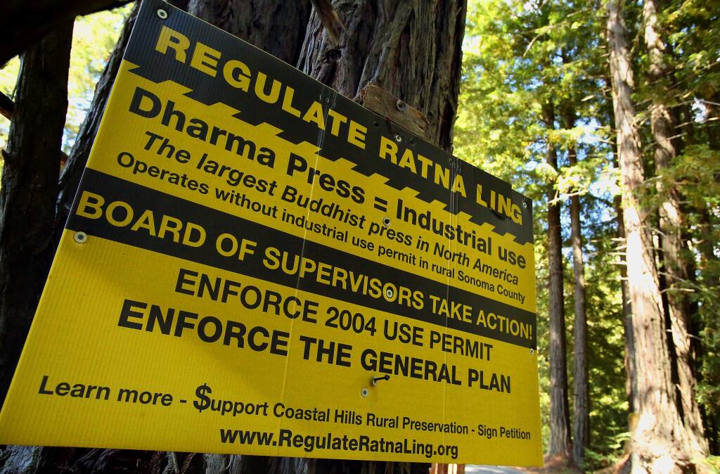 Opponents of Ratna Ling's publishing operation posted signs in the Cazadero area opposing the Buddhist retreat's publishing facility. (Christopher Chung/ The Press Democrat)