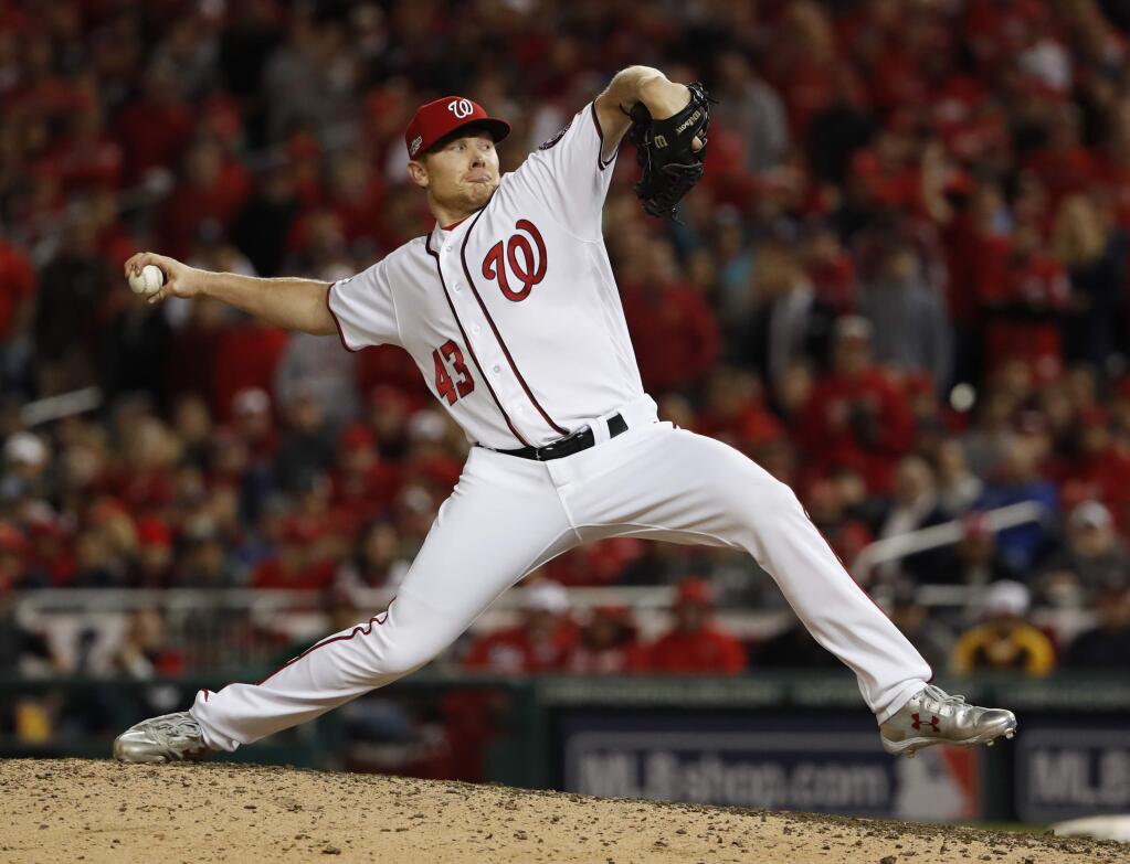 FILE - In a Thursday, Oct. 13, 2016 file photo, Washington Nationals relief pitcher Mark Melancon throws to a Los Angeles Dodgers batter during the eighth inning of Game 5 of a baseball National League Division Series, at Nationals Park, in Washington. The San Francisco Giants said Monday, Dec. 5, 2016, that they have agreed to a $62 million, four-year contract with closer Mark Melancon, pending a physical. (AP Photo/Pablo Martinez Monsivais, File)