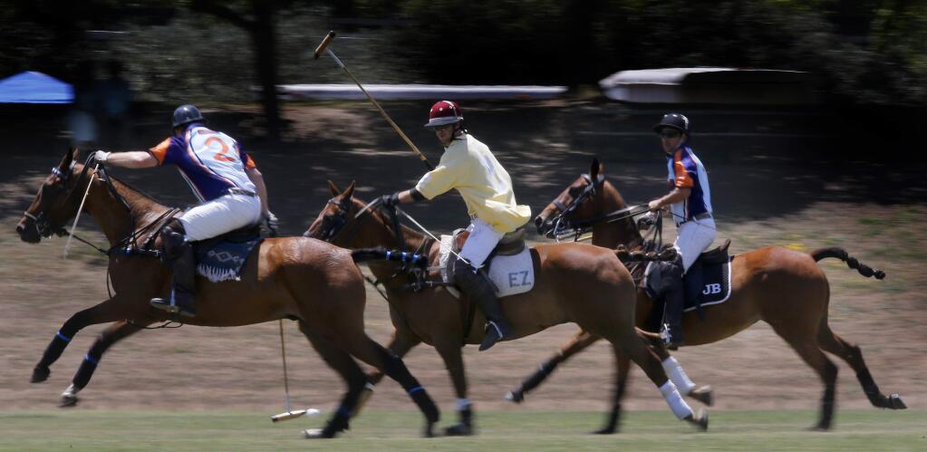 Members of the PoloSF Club and STG Group compete during the Henry F. Trione Memorial Polo Tournament at the Wine Country Polo Club on Sunday, July 12, 2015 in Santa Rosa, California . (BETH SCHLANKER/ The Press Democrat)
