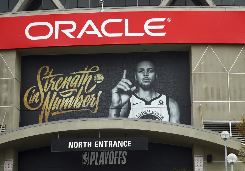 A banner depicting Golden State Warriors' Stephen Curry hangs on the exterior of Oracle Arena on Tuesday, April 10, 2018, in Oakland, Calif. (AP Photo/Ben Margot)