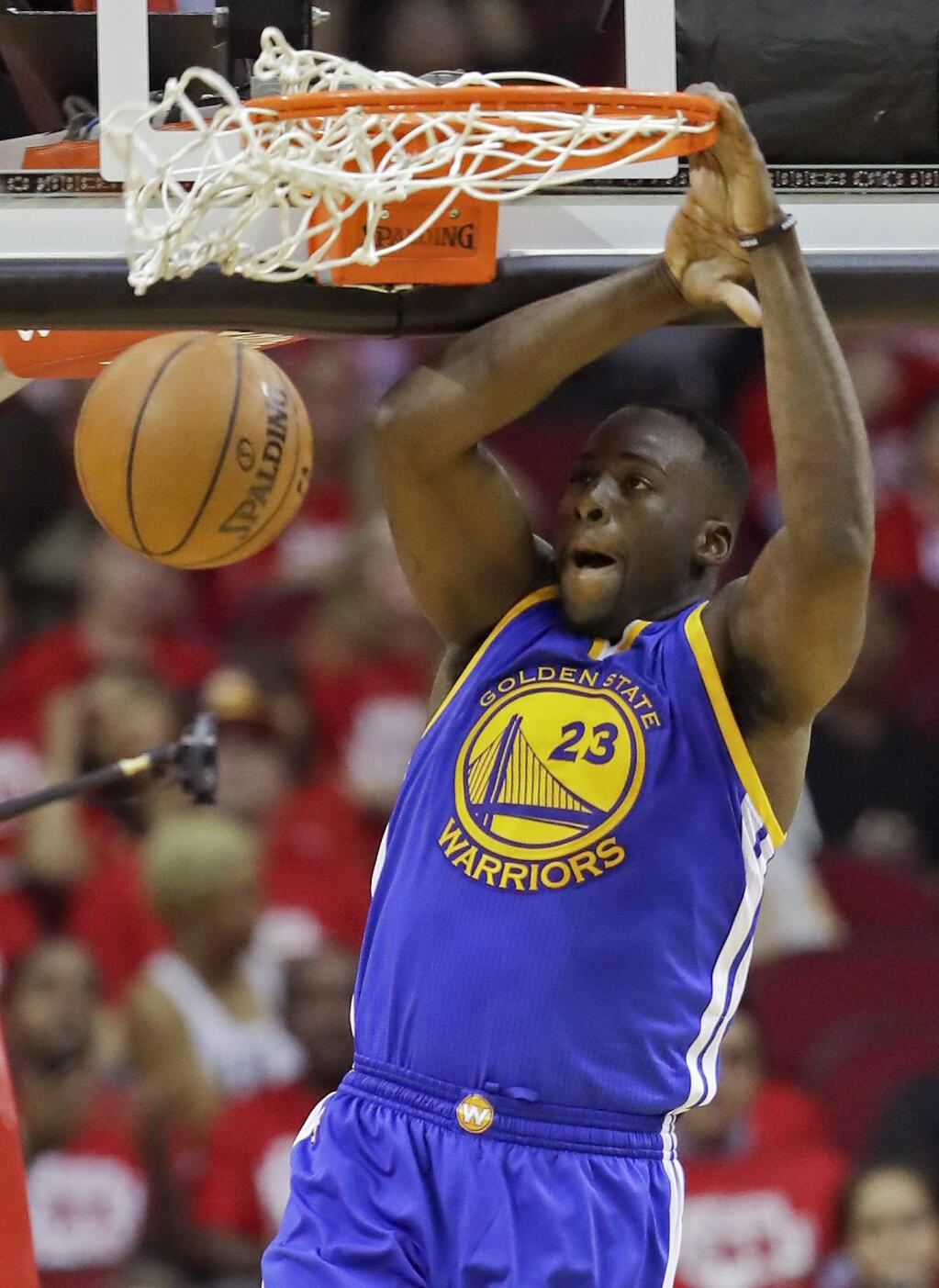 FILe - In this April 21, 2016, file photo, Golden State Warriors forward Draymond Green dunks against the Houston Rockets during the second half in Game 3 of a first-round NBA basketball playoff series, in Houston. Green was arrested for an alleged assault over the weekend in East Lansing, Michigan, according to online court records.The incident occurred around 2:30 a.m. Sunday, July 10, 2016, in the city where Green played for Michigan State from 2008-12.(AP Photo/David J. Phillip, File)