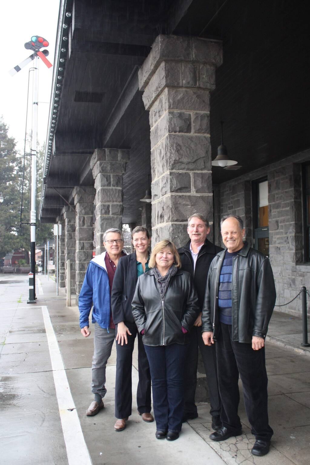 Urban Community Partnership founders (from left) David Petritz, Robin Stephani, Karen Weeks, Peter Stanley and Mitch Conner in front of the still undeveloped Railroad Square SMART station in Santa Rosa on Jan. 14, 2016. Paul Fritz is not pictured. (Gary Quackenbush / North Bay Business Journal)