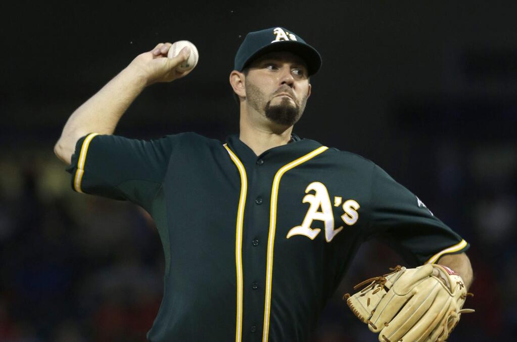 Oakland Athletics starting pitcher Jason Hammel throws during the first inning of a baseball game against the Texas Rangers in Arlington, Texas, Thursday, Sept. 25, 2014. (AP Photo/LM Otero)