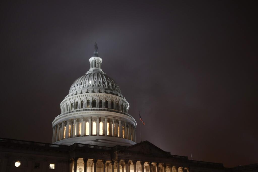 FILE - In this Dec. 9, 2019, file photo mist rolls over the U.S. Capitol dome on Capitol Hill in Washington. (AP Photo/Patrick Semansky, File)