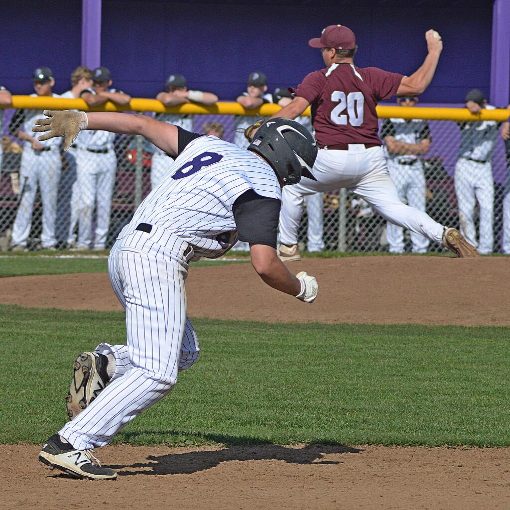 SUMNER FOWLER FOR THE ARGUS-COURIERPetaluma's Connor Richardson is off and running as Piner pitcher Jacob Shipman delivers to the plate during Petaluma's SCL win.