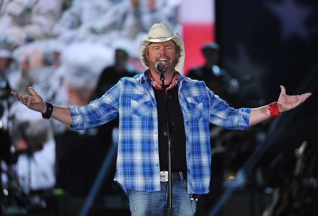 FILE - In this April 7, 2014, file photo shows Toby Keith performs at ACM Presents an All-Star Salute to the Troops in Las Vegas. Keith performed a tribute to the late legend Merle Haggard during the American Country Countdown Awards on May 1, 2016. (Photo by Chris Pizzello/Invision/AP, File)