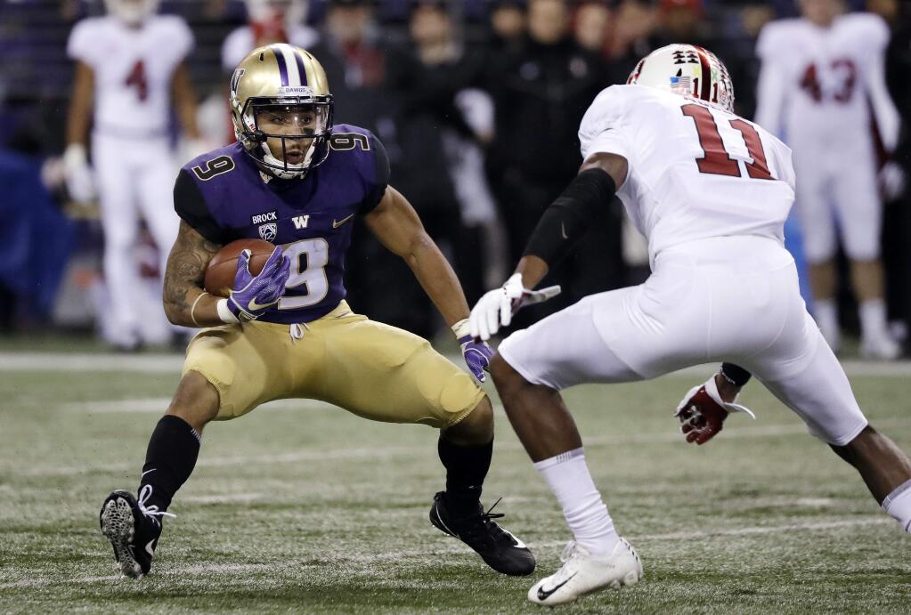 Washington's Myles Gaskin (9) carries as Stanford's Paulson Adebo moves in during the first half of an NCAA college football game Saturday, Nov. 3, 2018, in Seattle. (AP Photo/Elaine Thompson)