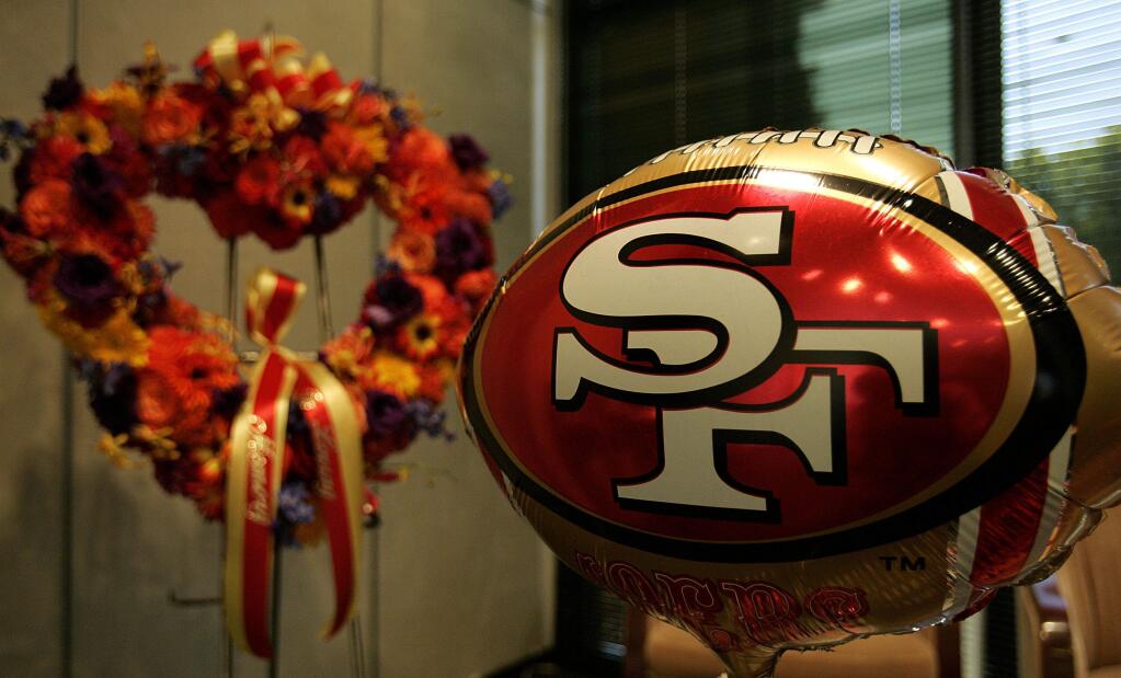 Flowers in memory of 49ers offensive lineman Thomas Herrion are seen at the 49ers headquarters lobby after Herrion's death in August 2005. (Ben Margot / Associated Press)