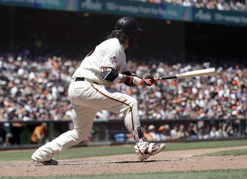 San Francisco Giants' Brandon Crawford drives in two runs with a double against the San Diego Padres during the sixth inning of a baseball game Saturday, June 23, 2018, in San Francisco. (AP Photo/Marcio Jose Sanchez)