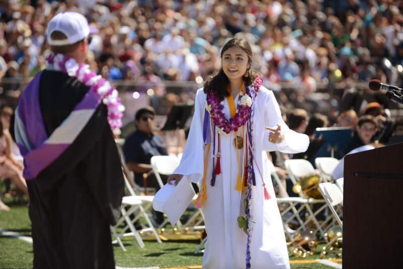 Lulabel Seitz, right, argues with Petaluma High School Principal David Stirrat after her microphone was shut off by school officials during her valedictorian speech at the Petaluma High School graduation ceremony. (Photo: Erik Castro/for the Press Democrat.