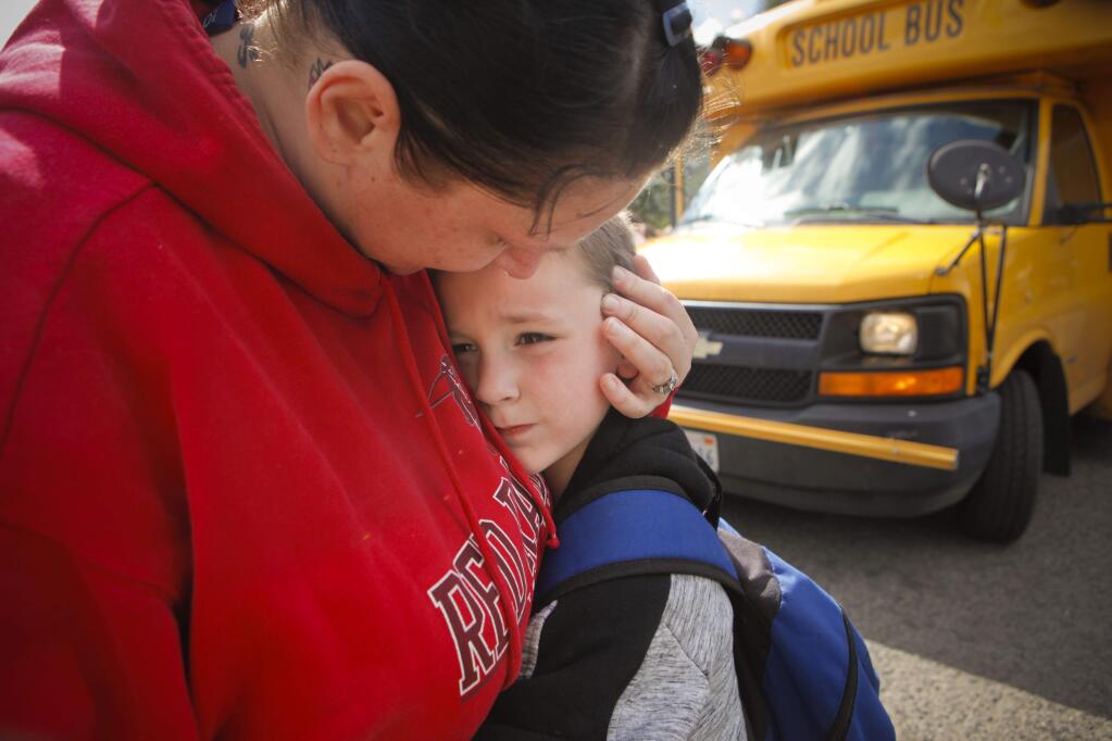 Michelle Brown's son, Keith Slatt, 7, was dropped off by the school bus for the last time. They will be moving in with Michelle's mother in Sacramento. (CRISSY PASCUAL/ARGUS-COURIER STAFF)