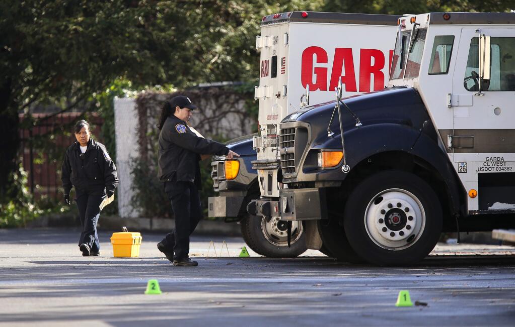 Santa Rosa Police Department field evidence technicians gather evidence at the scene of an officer involved shooting during a robbery attempt at the GardaWorld facility on Northpoint Parkway, in Santa Rosa on Friday, March 2, 2018. (Christopher Chung/ The Press Democrat)