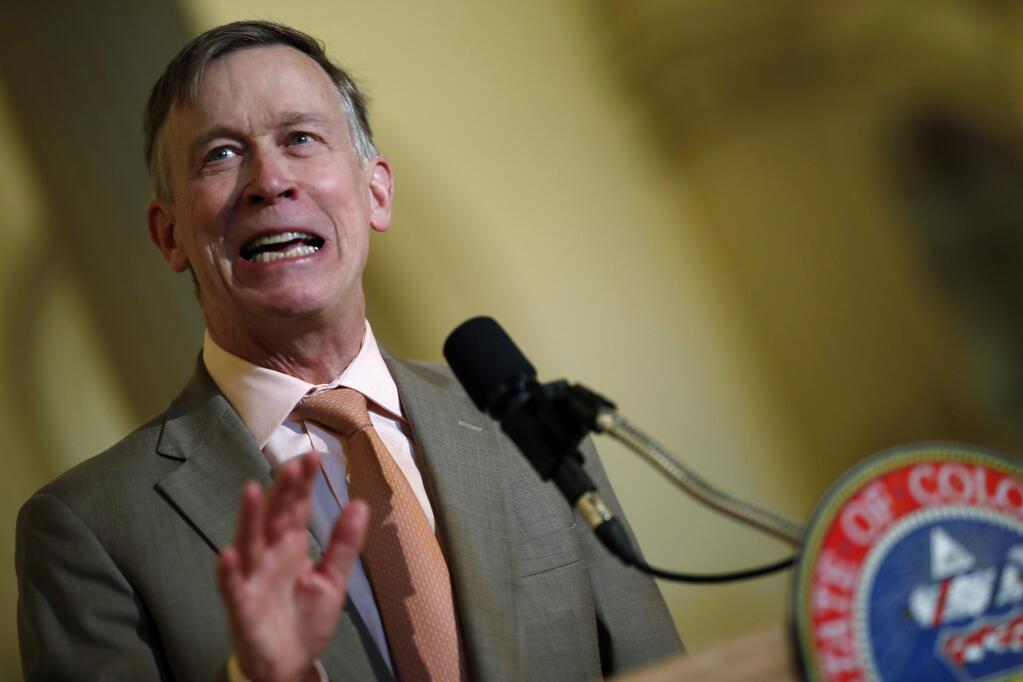 In this May 30,2018 file photo Colorado Gov. John Hickenlooper speaks at the state Capitol. On Tuesday, June 19, 2018, Hickenlooper ordered state regulators to adopt California's vehicle pollution rules, joining other states in resisting the Trump administration's plans to ease up on emissions standards. Hickenlooper, a Democrat, told regulators to try to have the new vehicle standards in place by the end of the year. (AP Photo/David Zalubowski,File)