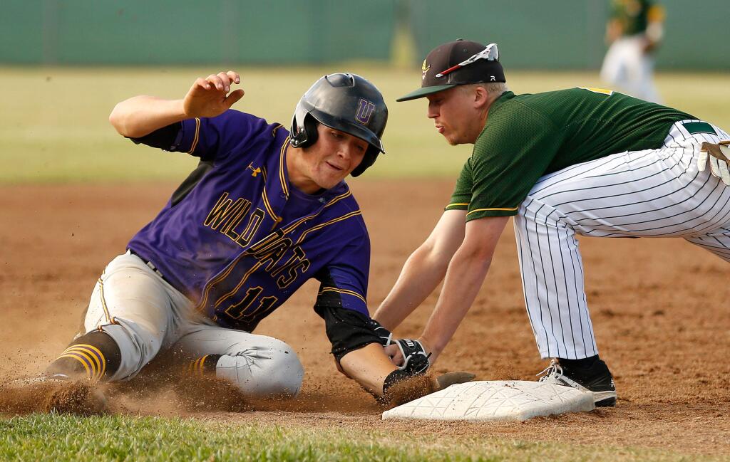 Casa Grande third baseman Dylan Moore, right, tags Ukiah's Keegan Beebe out in the top of the fourth inning of the NCS Division II semifinal game between Ukiah and Casa Grande high schools in Petaluma on Wednesday, May 31, 2017. (Alvin Jornada / The Press Democrat)
