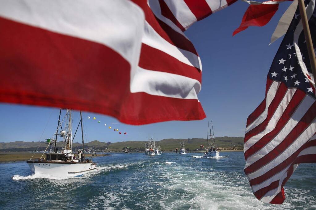 The Suzan E, left, joins a number of other fishing boats during the Boat Parade as part of the 42nd annual Bodega Bay Fisherman's Festival on Sunday, April 12, 2015 in Bodega Bay, California . (BETH SCHLANKER/ The Press Democrat)