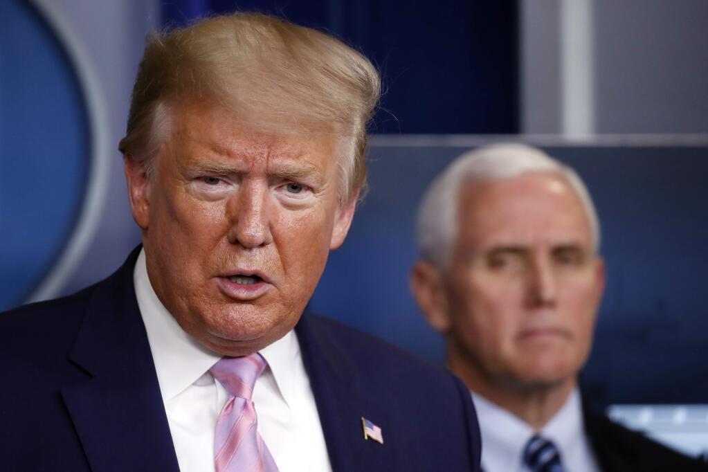 President Donald Trump speaks about the coronavirus in the James Brady Press Briefing Room of the White House, Wednesday, April 1, 2020, in Washington, as Vice President Mike Pence listens. (AP Photo/Alex Brandon)
