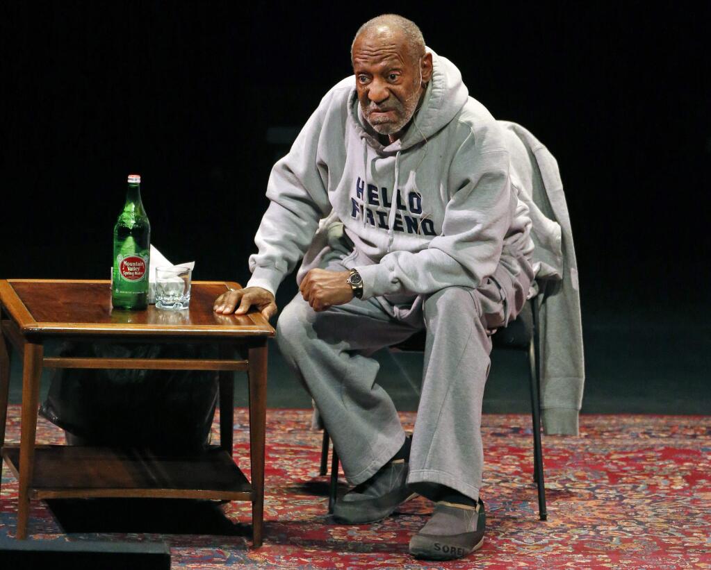 FILE - In this Jan. 17, 2015 file photo, comedian Bill Cosby performs at the Buell Theater in Denver. The Fox Theater in Bakersfield, Calif., announced that Cosby's comedy performance scheduled for Feb. 12, 2015, has been postponed and not yet rescheduled. (AP Photo/Brennan Linsley, File)