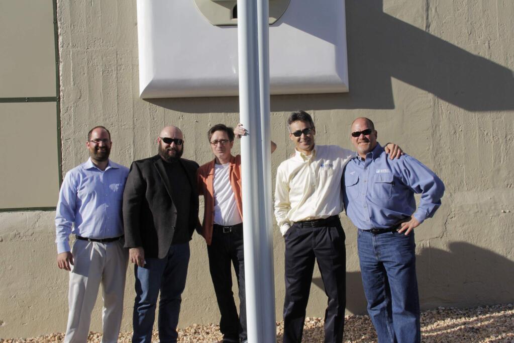 From left to right, Brian Bettari, John John Ghigliazza, artist Joel Jones, Ron Van Hoosear and Bob Murphy all PG&E executives except Jones who backed and promoted this art during the unveiling reception of the sculpture by fabricator Shawn Thorsson and artist Joel Jones at the1st and D Street PG&E substation in Petaluma on Friday, July 10, 2015. (Jim Johnson/For the Argus-Courier)