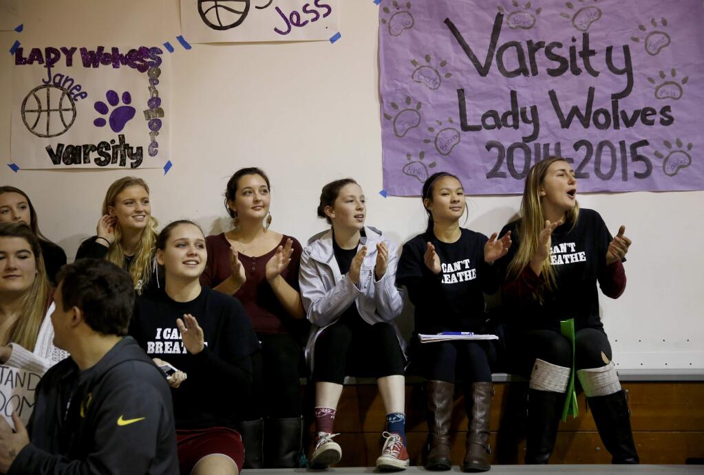 Members of the Mendocino High girl's basketball team and classmates watch the Mendocino High boy's team compete during a basketball tournament at Ft. Bragg High School in Ft. Bragg, California on Monday, December 29, 2014. (BETH SCHLANKER/ The Press Democrat)