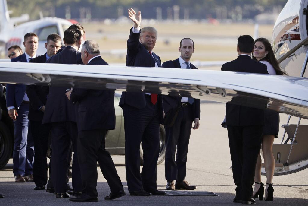 Republican presidential candidate Donald Trump waves before boarding a plane after a campaign rally, Thursday, Sept. 29, 2016, in Bedford, N.H. (AP Photo/John Locher)