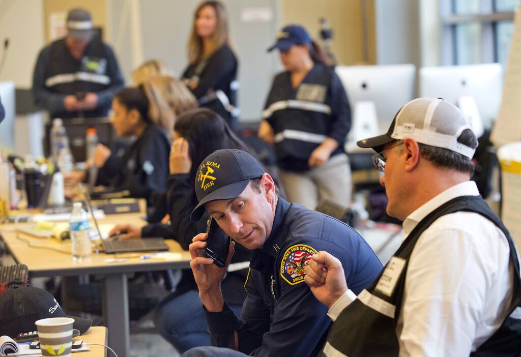 From right, Santa Rosa City Manager Sean McGlynn works with Santa Rosa County Assistant Fire Marshal Paul Lowenthal at the Santa Rosa Emergency Operations Center on Thursday. (photo by John Burgess/The Press Democrat)