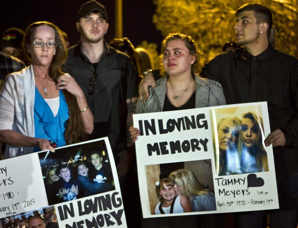 In this Tuesday, Feb. 17, 2015, photo, people participate in a candlelight vigil for Tammy Meyers, who was taken off life support on Saturday after a shooting in Las Vegas. What police first described as a road rage-inspired shooting of an innocent mother of four has morphed into a more complex scenario, prompting a backlash Wednesday against the Las Vegas family and the way the case is being handled. (AP Photo/Las Vegas Sun, L.E. Baskow) LAS VEGAS REVIEW-JOURNAL OUT