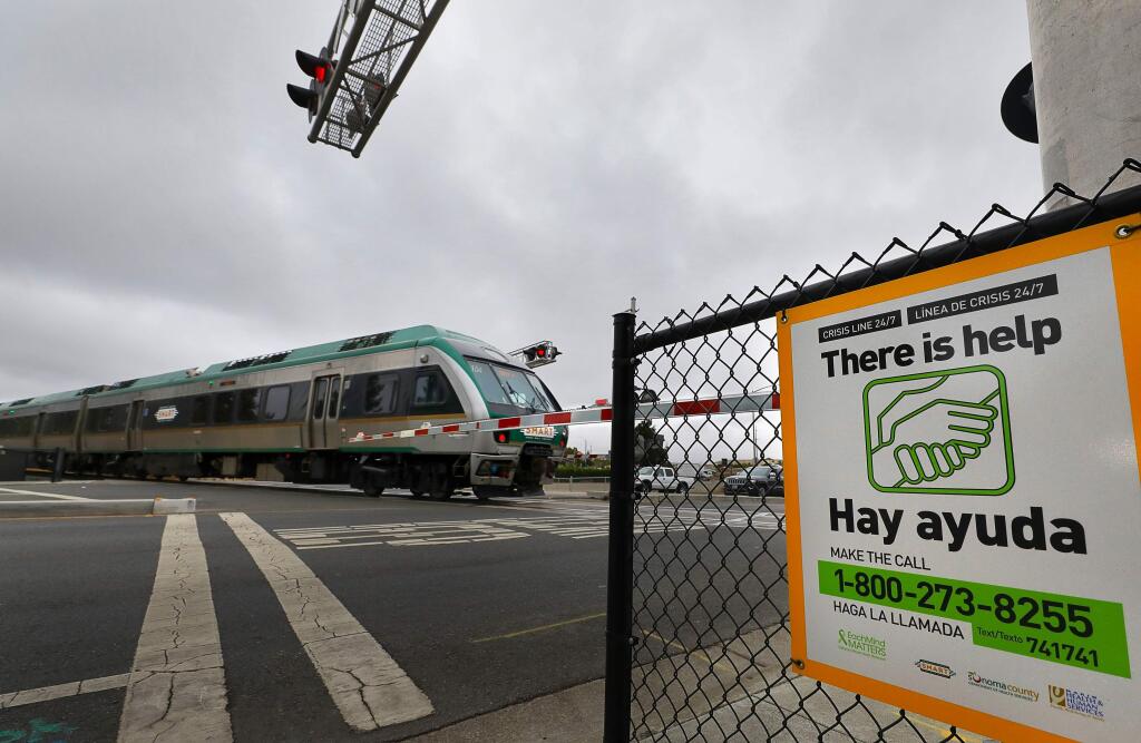 A SMART train crosses the intersection at Golf Course Drive, in Rohnert Park on Friday, September 27, 2019. (Christopher Chung/ The Press Democrat)