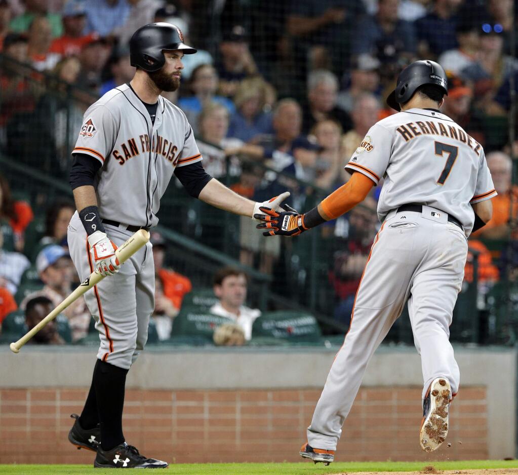 The San Francisco Giants' Brandon Belt, left, congratulates Gorkys Hernandez after scoring the first run of the game during the fourth inning Wednesday, May 23, 2018, in Houston. (AP Photo/Michael Wyke)