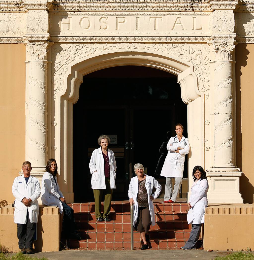 Members of Health Professionals for Equality and Community Empowerment (H-PEACE), from left: Dr. Rick Flinders, Dr. Veronica Jordan, registered nurse Jerilu Breneman, Dr. Panna Lossy, Dr. Ember Keighley, and registered nurse Ocotlan Sasturrias stand at the main entrance of the former Sutter Hospital on Chanate Road in Santa Rosa, California, on Friday, May 26, 2017. (Alvin Jornada / The Press Democrat)