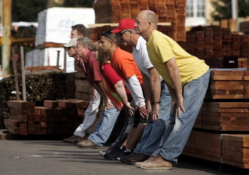 secondary/2 of 2__Construction workers and employees of Central Valley Builders Supply in St. Helena use a stack of lumber for balance as they stretch their backs in a yoga class taught by Allan Nett on Friday, March 30, 2007.photo by John Burgess/The Press Democrat