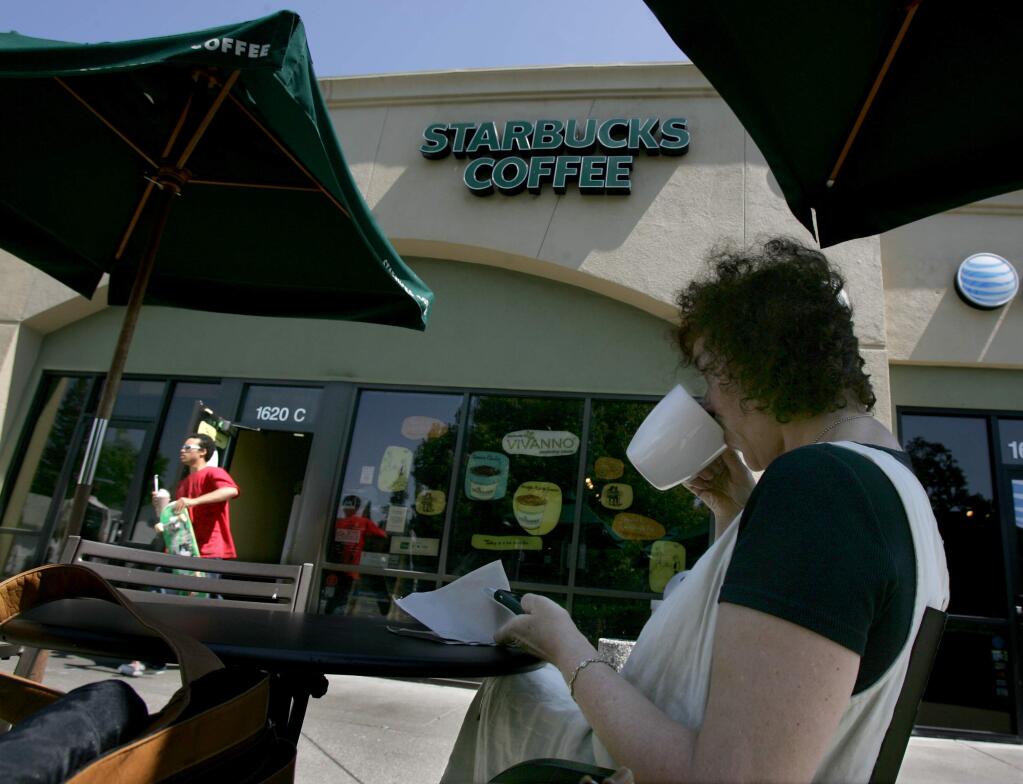 Joanne Butcher of San Francisco sips coffee at a Starbucks in Santa Rosa in 2008. (PD FILE)