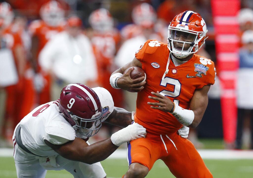 Clemson quarterback Kelly Bryant (2) is sacked by Alabama defensive lineman Da'Shawn Hand (9) in the second half of the Sugar Bowl semi-final playoff game for the NCAA college football national championship, in New Orleans, Monday, Jan. 1, 2018. (AP Photo/Butch Dill)