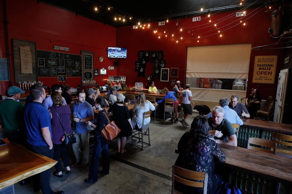 Customers enjoy live music, craft brews and conversation at Moonlight Brewing Company in Santa Rosa, California, on Thursday, July 18, 2019. (Alvin Jornada / The Press Democrat)