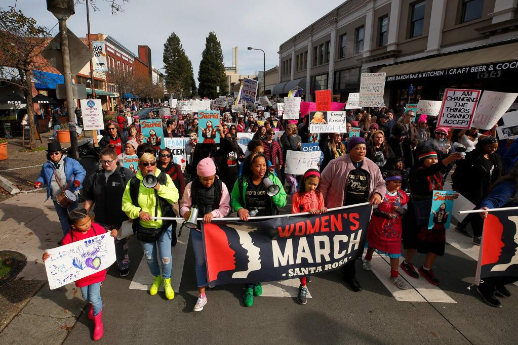 Hundreds of participants walk down 4th Street during the Women's March in Santa Rosa, California, on Saturday, January 18, 2020. (Alvin Jornada / The Press Democrat)