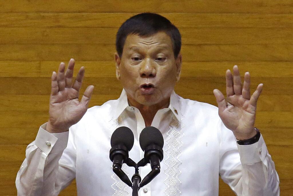 Philippine President Rodrigo Duterte gestures during his second State of the Nation Address at the House of Representatives in suburban Quezon city, north of Manila, Philippines Monday July 24, 2017. (AP Photo/Aaron Favila)