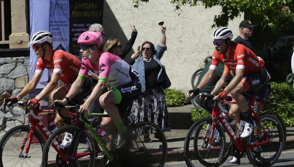 Cyclists are cheered on as they race through Placerville, Calif., during the sixth stage of the Amgen Tour of California cycling race, Friday, May 18, 2018. (AP Photo/Rich Pedroncelli)