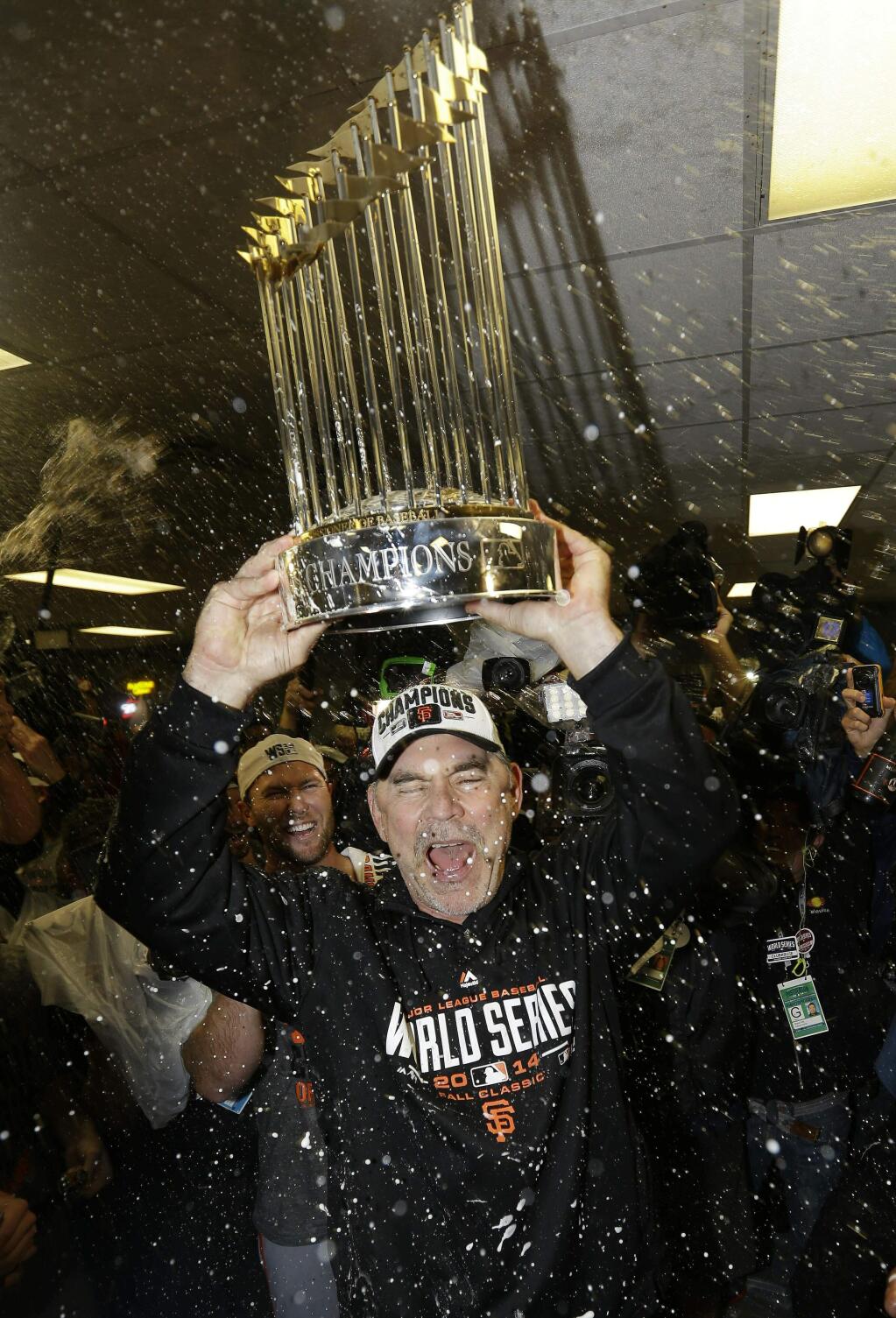 FILE - In this Oct. 29, 2014, file photo, San Francisco Giants manager Bruce Bochy celebrates after Game 7 of baseball's World Series against the Kansas City Royals, in Kansas City, Mo. Bochy says he will retire after this season, his 25th as a big league manager. Bochy says he told the team of his decision on Monday, Feb. 18, 2019. (AP Photo/David J. Phillip, File)