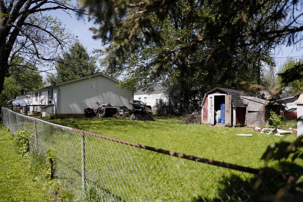 A shed stands in a backyard where police say a man with mental health problems kidnapped a neighbor and kept her trapped in a small grave-like pit in the shed Wednesday, April 26, 2017, in Blanchester. Ohio. Police in Blanchester, about 40 miles northeast of Cincinnati, said the owner of the shed, Dennis Dunn, was arrested on Wednesday and was taken to a hospital. (AP Photo/John Minchillo)
