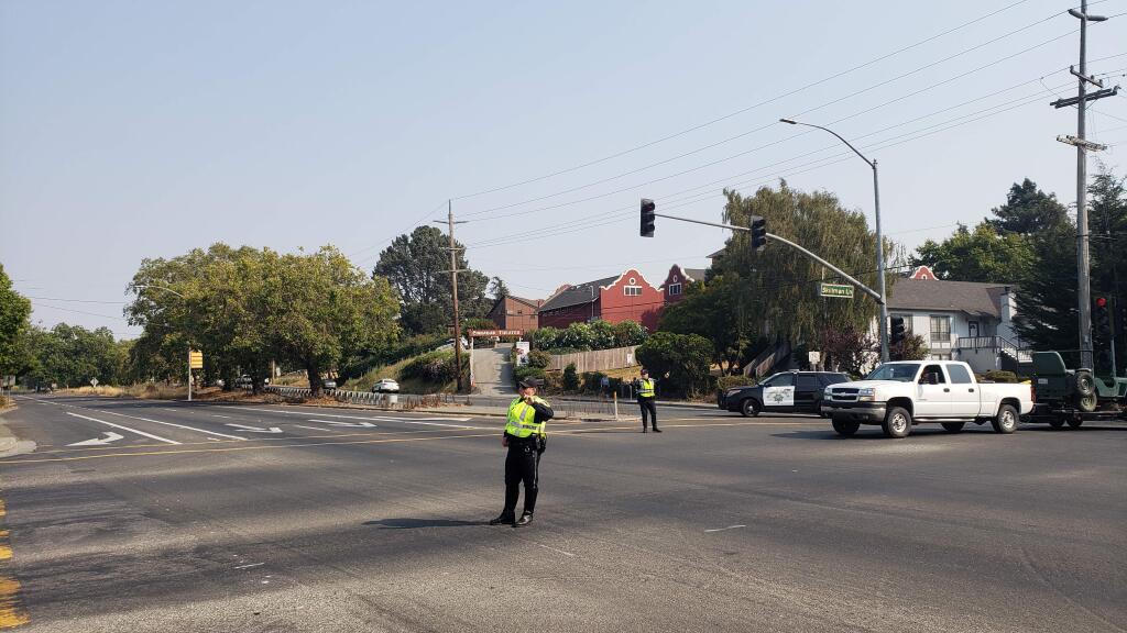 Petaluma police and CHP officers redirect traffic at the intersection of Petaluma Boulevard North and Skillman Lane due to a standoff at a house on Petaluma Boulevard. (Alvin Jornada / The Press Democrat)